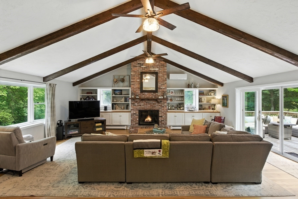 61 Pond Street Boxford, MA 01921 - Photo 11 of 38 a living room with furniture a fireplace and a large window