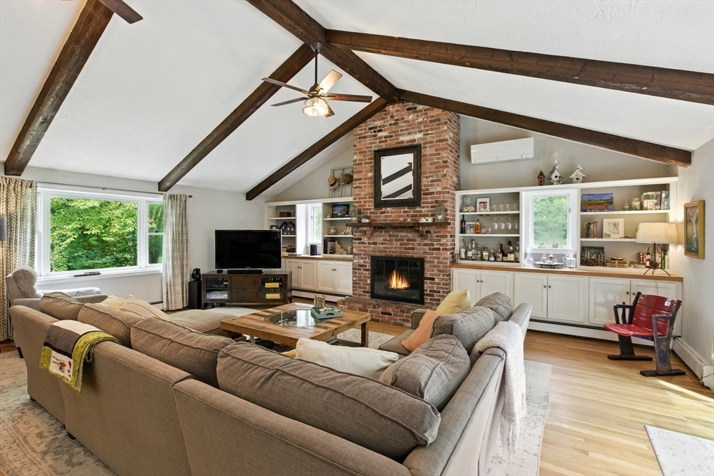 61 Pond Street Boxford, MA 01921 - Photo 13 of 38 a living room with furniture a fireplace and a flat screen tv
