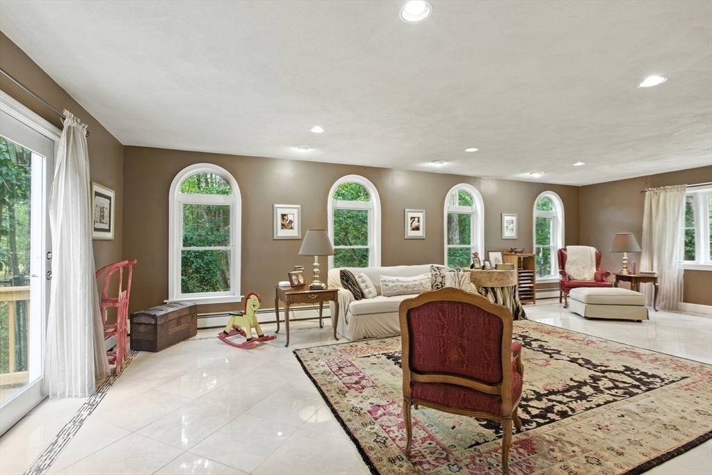 61 Pond Street Boxford, MA 01921 - Photo 15 of 38 a living room with furniture fireplace and large windows