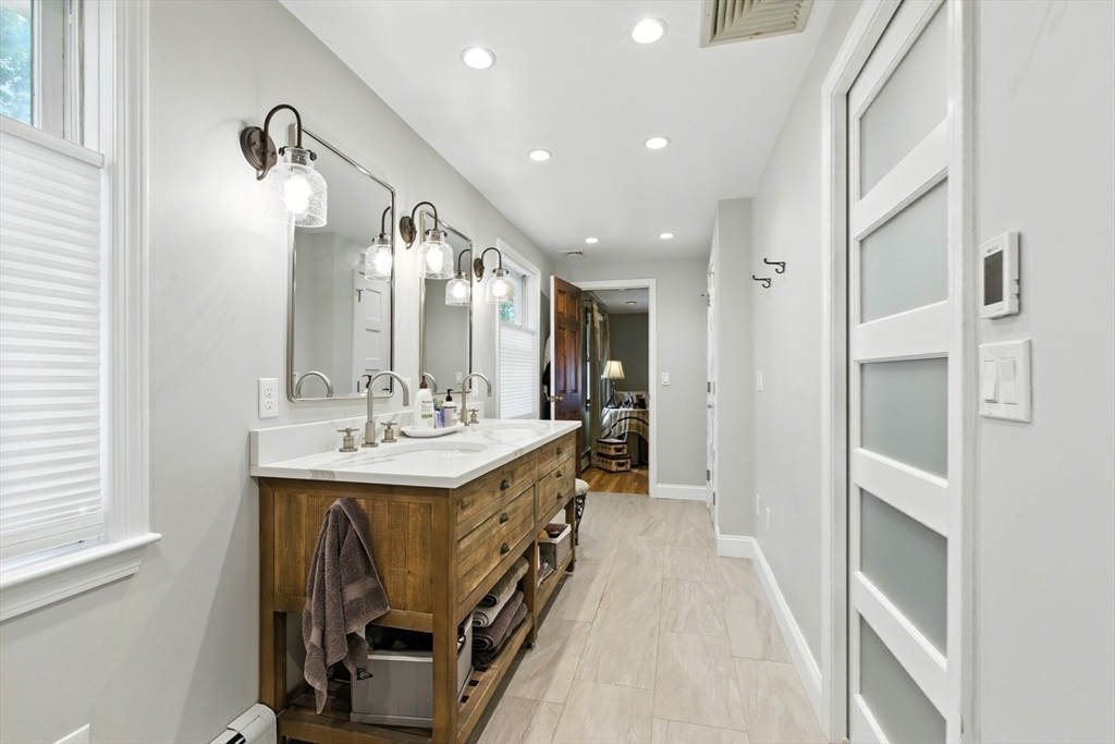 61 Pond Street Boxford, MA 01921 - Photo 22 of 38 a bathroom with a sink a mirror and a shower