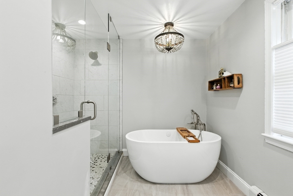 61 Pond Street Boxford, MA 01921 - Photo 24 of 38 a bathroom with a bathtub and shower