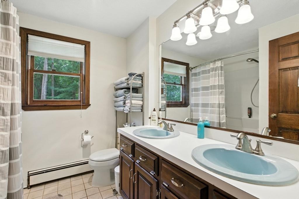61 Pond Street Boxford, MA 01921 - Photo 31 of 38 a bathroom with a sink vanity mirror and toilet