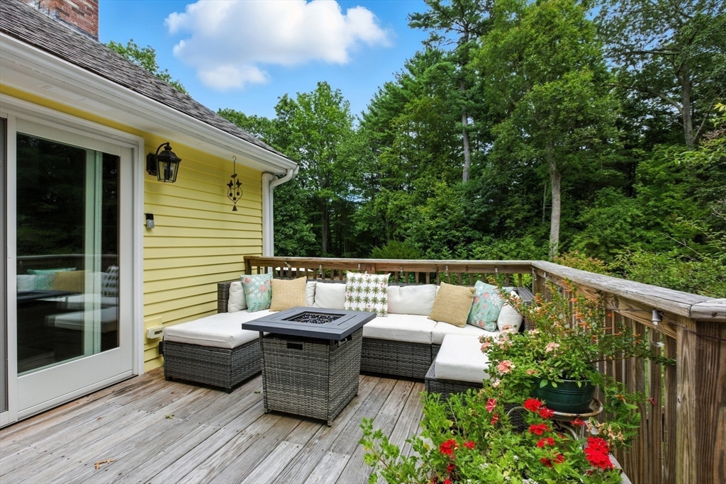 61 Pond Street Boxford, MA 01921 - Photo 34 of 38 a view of a patio with couches table and chairs and potted plants