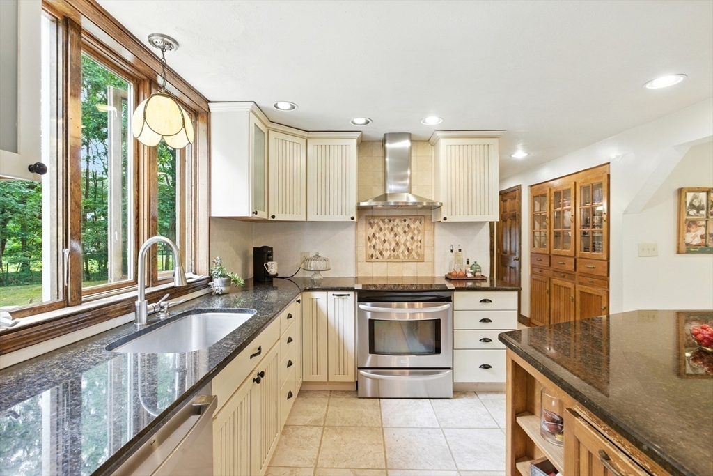 61 Pond Street Boxford, MA 01921 - Photo 7 of 38 a kitchen with stainless steel appliances granite countertop a stove a sink and a microwave