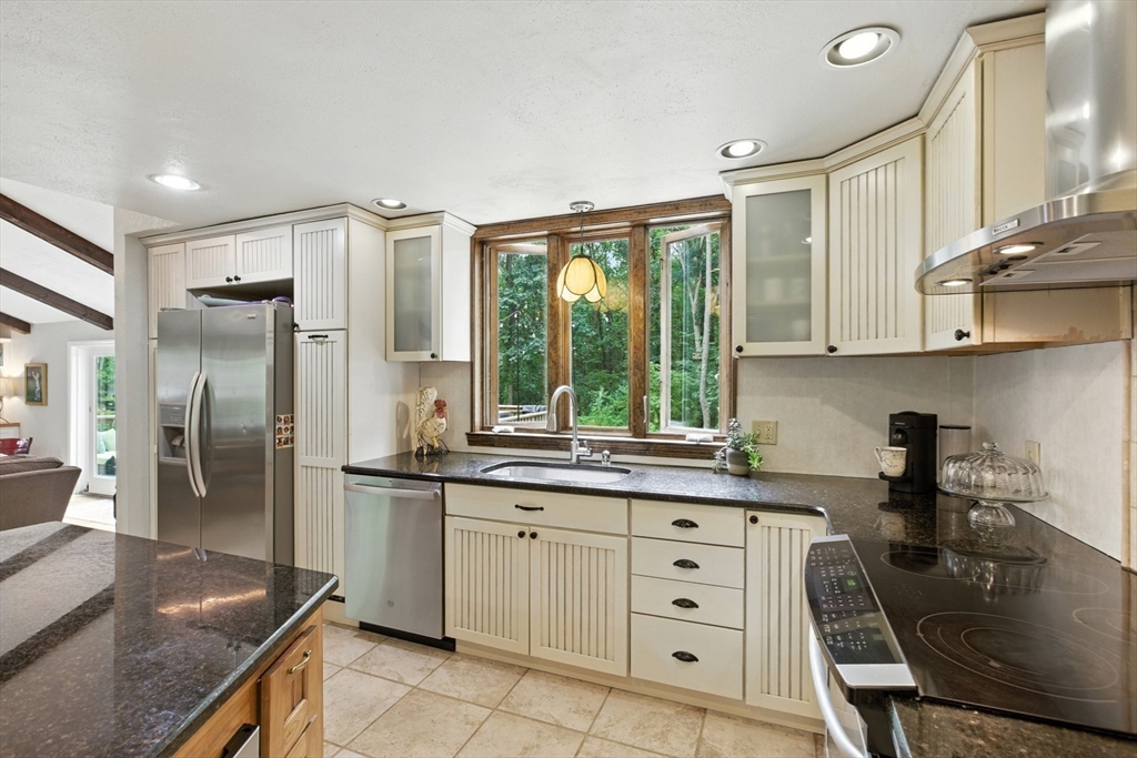 61 Pond Street Boxford, MA 01921 - Photo 8 of 38 a kitchen with stainless steel appliances granite countertop a sink stove and refrigerator