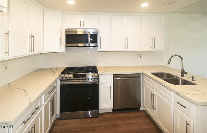 3224 Sunset Lane Oxnard, CA 93035 - Photo 4 of 20 a kitchen with stainless steel appliances granite countertop a stove and a sink