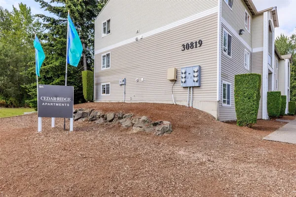 a view of a house with a yard and sitting area