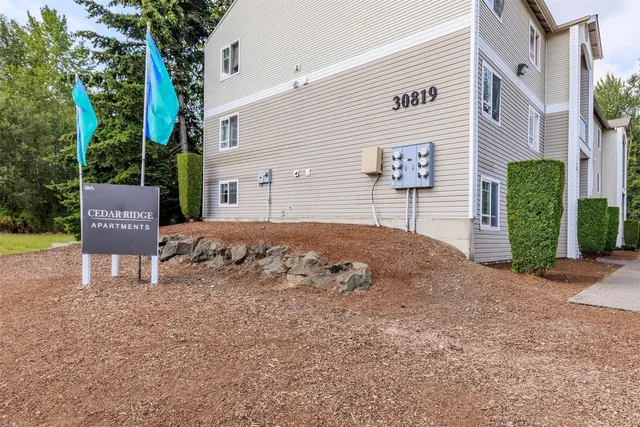 a view of a house with a yard and sitting area