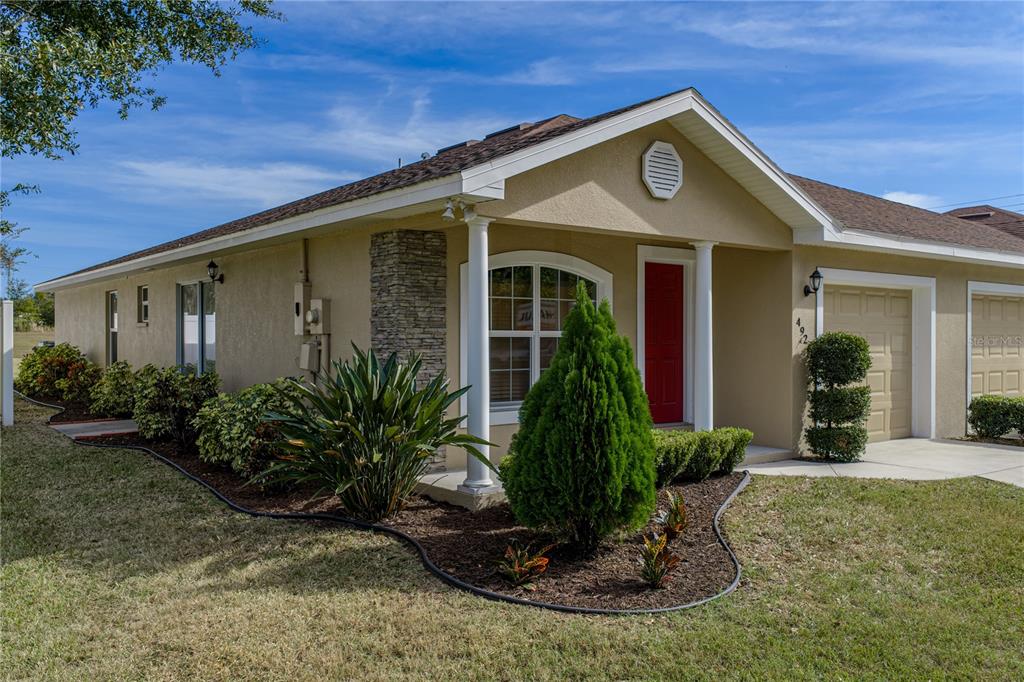 a front view of a house with garden