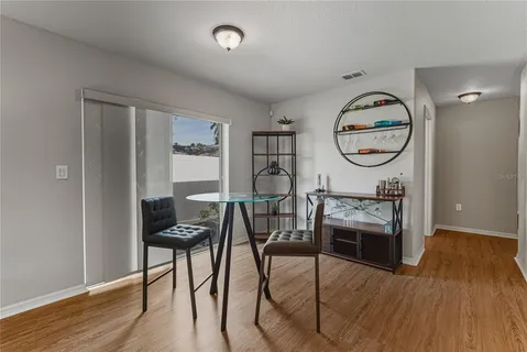 a living room with furniture a clock and wooden floor
