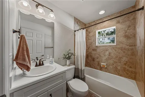 a bathroom with a sink a toilet and a bathtub