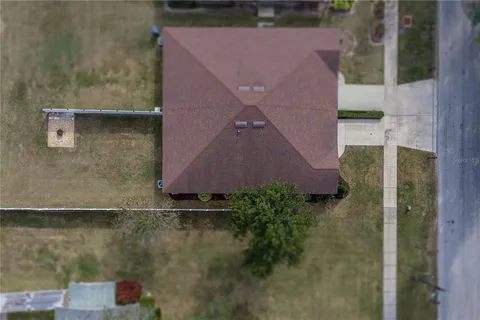 an aerial view of a house with a yard