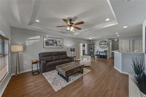 a living room with furniture and wooden floor