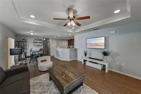 a living room with furniture and a wooden floor