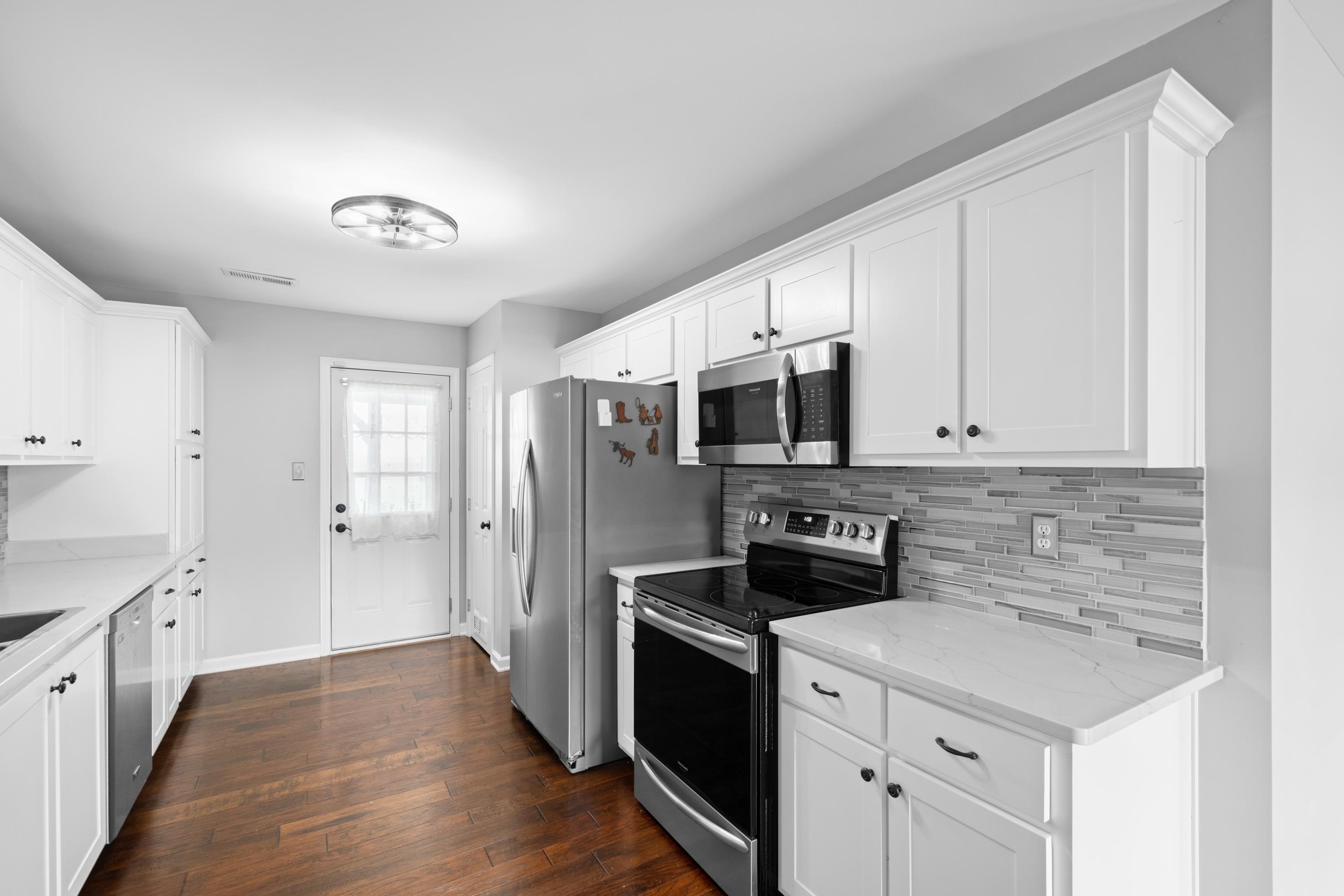 a kitchen with stainless steel appliances a sink stove and refrigerator