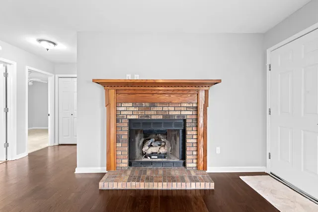 a view of a room with wooden floor and a ceiling fan