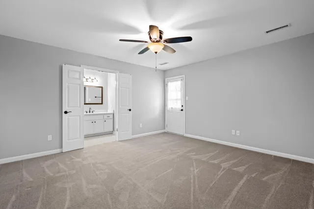 a view of a livingroom with a ceiling fan & a ceiling fan
