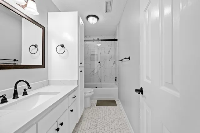 an empty room with a ceiling fan and window