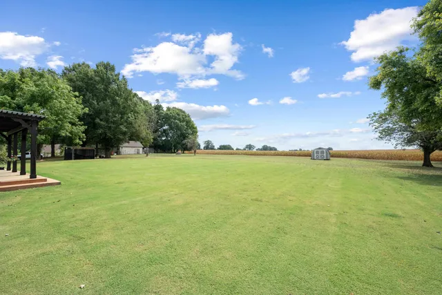 a front view of a house with a garden and yard