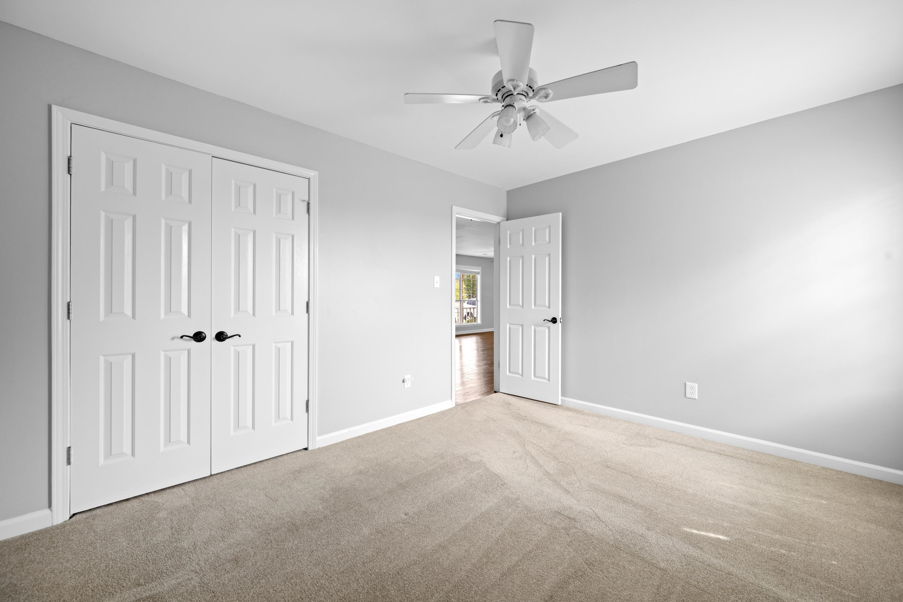 225 Brierhedge Road Covington, TN 38019 - Photo 8 of 34 Unfurnished bedroom with carpet floors, ceiling fan, and a closet