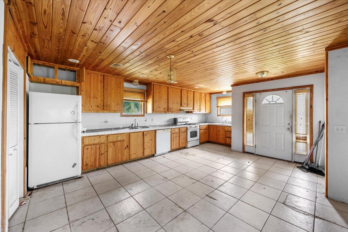 5704 Arnold Road Panama City, FL 32404 - Photo 17 of 25 a large kitchen with stainless steel appliances granite countertop a refrigerator and a stove