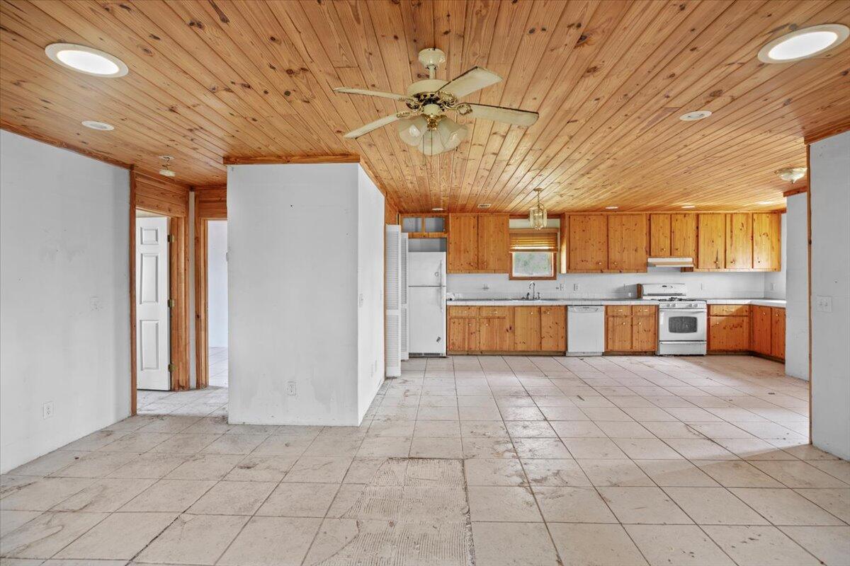 5704 Arnold Road Panama City, FL 32404 - Photo 19 of 25 a big room with stainless steel appliances kitchen island granite countertop a refrigerator and a stove