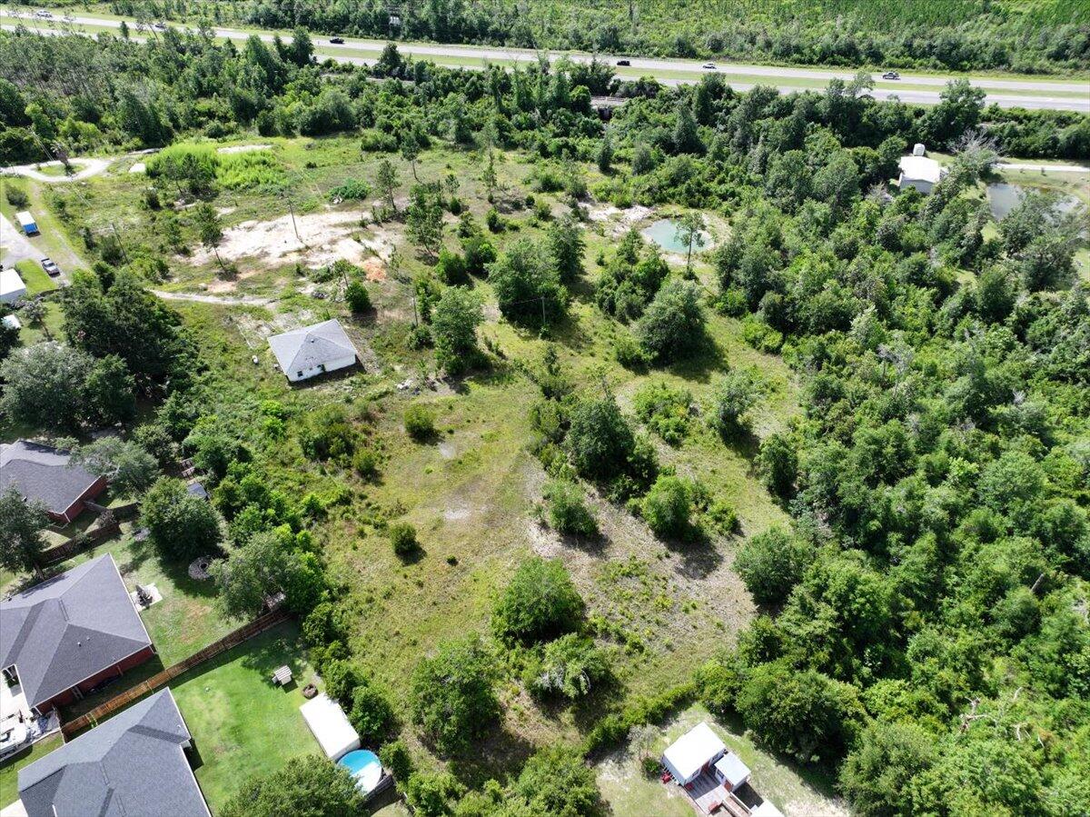 5704 Arnold Road Panama City, FL 32404 - Photo 2 of 25 an aerial view of residential house with outdoor space and trees all around