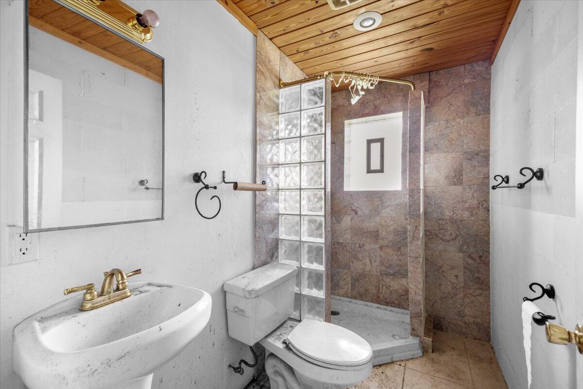 5704 Arnold Road Panama City, FL 32404 - Photo 24 of 25 a bathroom with a toilet sink and shower