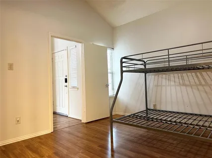 a view of a room with wooden floor