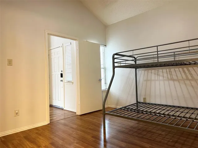 a view of a room with wooden floor