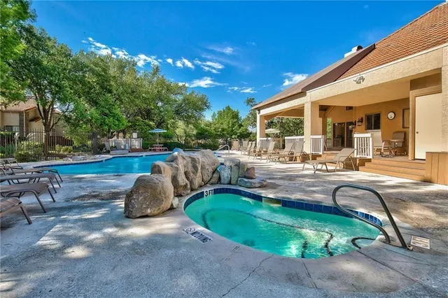 a swimming pool with outdoor seating and yard