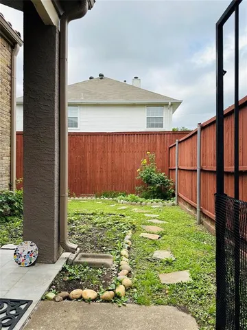 a view of backyard with potted plants