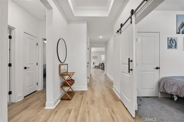 a view of a room with wooden floor and white walls