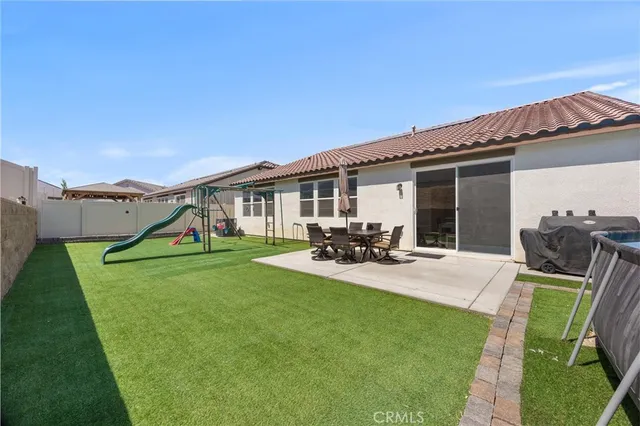 a view of a big room with wooden floor and windows