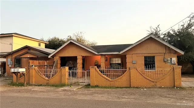 a view of a house with wooden fence