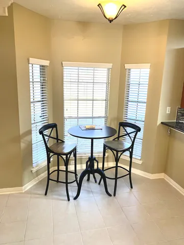 a view of a livingroom with furniture and a window
