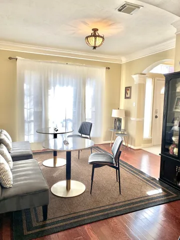 a living room with fireplace furniture and a large window