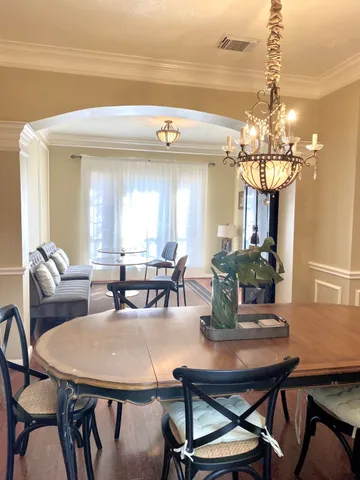 a view of a dining room with furniture and chandelier