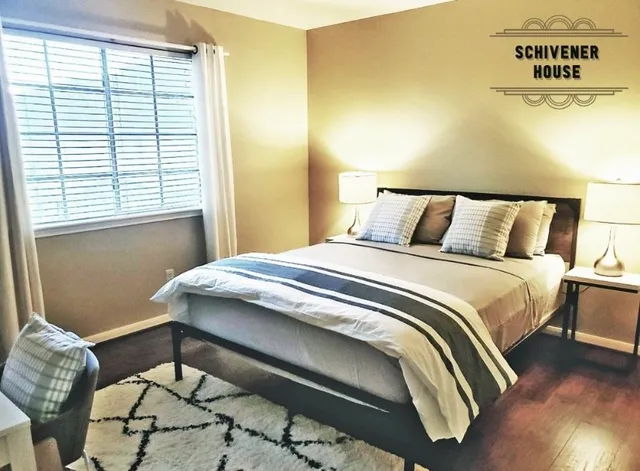 a bed sitting in a bedroom next to a window