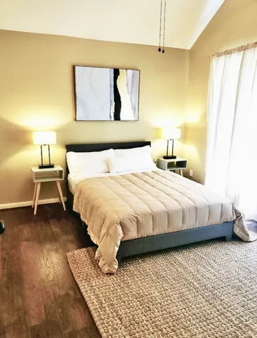a bedroom with a bed and lamp