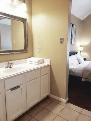 a spacious bathroom with a sink and a mirror