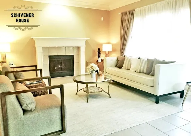 a living room with furniture and a fireplace