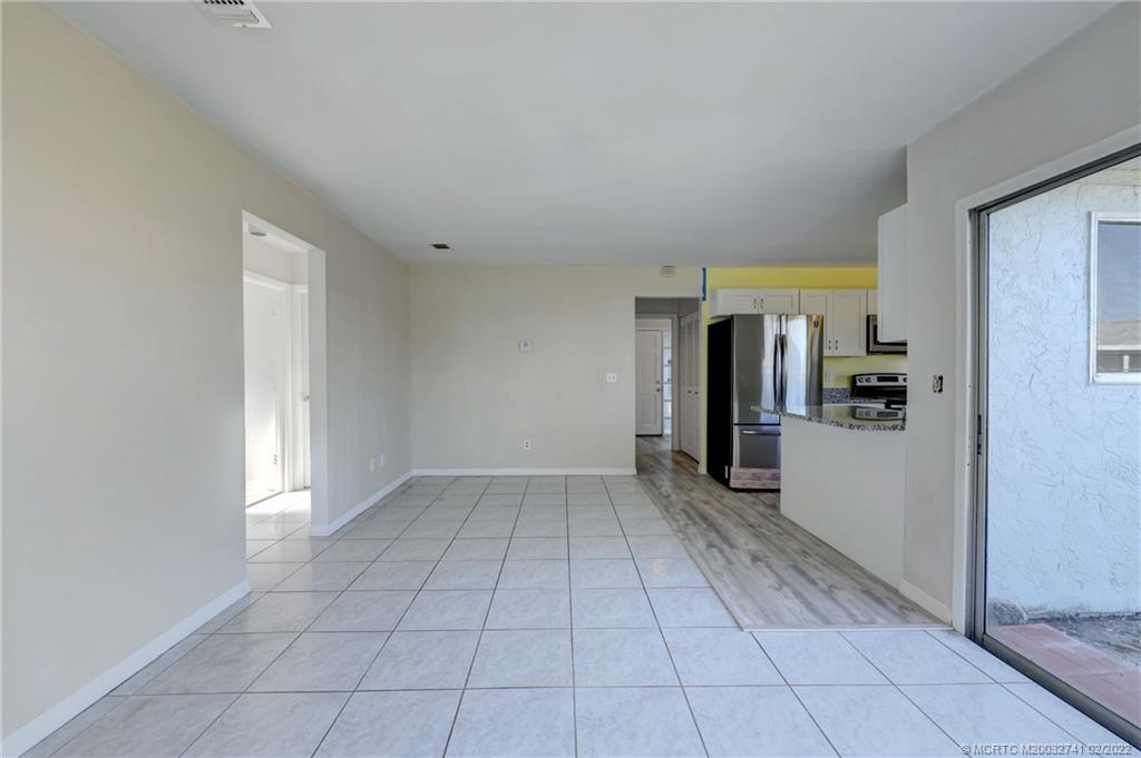 297 Southwest Homeland Road Port St. Lucie, FL 34953 - Photo 14 of 32 a view of a closet area with living room
