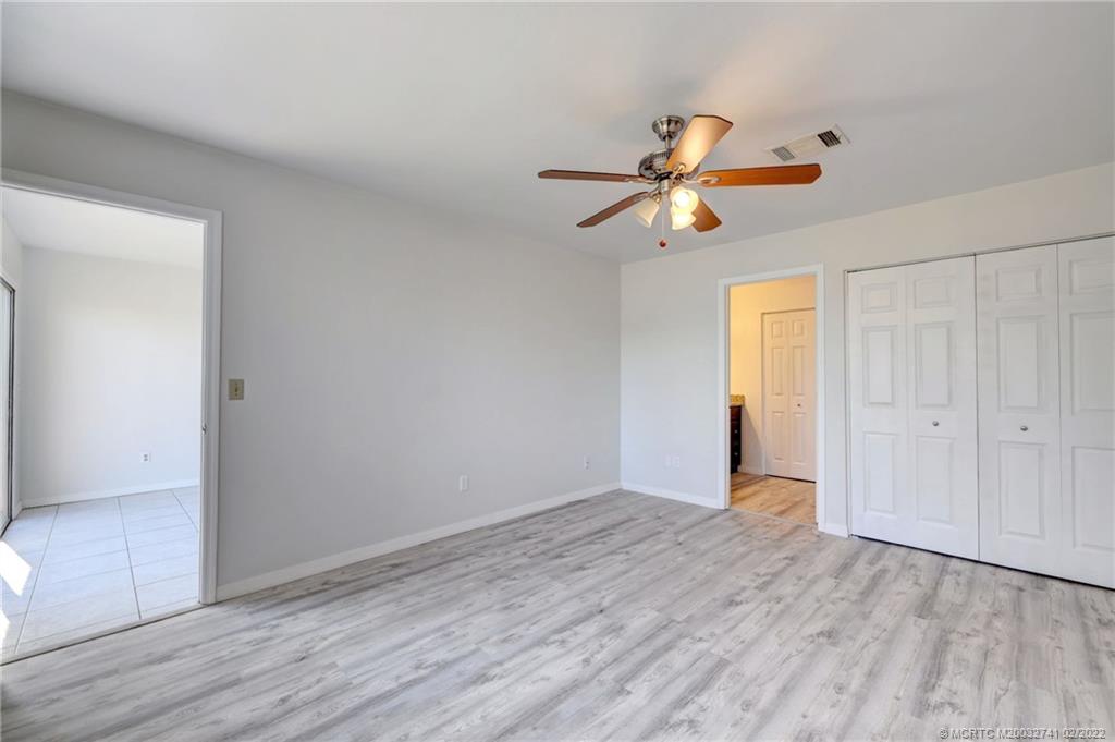 297 Southwest Homeland Road Port St. Lucie, FL 34953 - Photo 20 of 32 a view of room with a ceiling fan and window