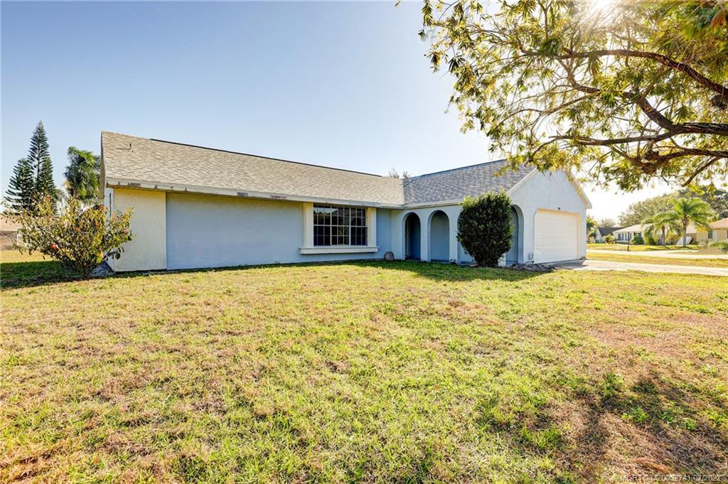 297 Southwest Homeland Road Port St. Lucie, FL 34953 - Photo 2 of 32 a view of a house with a yard