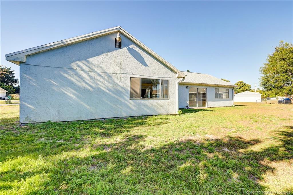 297 Southwest Homeland Road Port St. Lucie, FL 34953 - Photo 30 of 32 a house view with a outdoor space