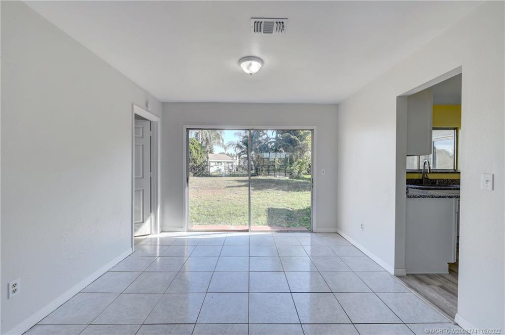 297 Southwest Homeland Road Port St. Lucie, FL 34953 - Photo 7 of 32 a view of an empty room with a window