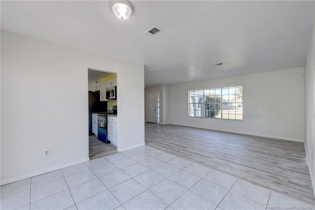 297 Southwest Homeland Road Port St. Lucie, FL 34953 - Photo 8 of 32 an empty room with windows and entrance