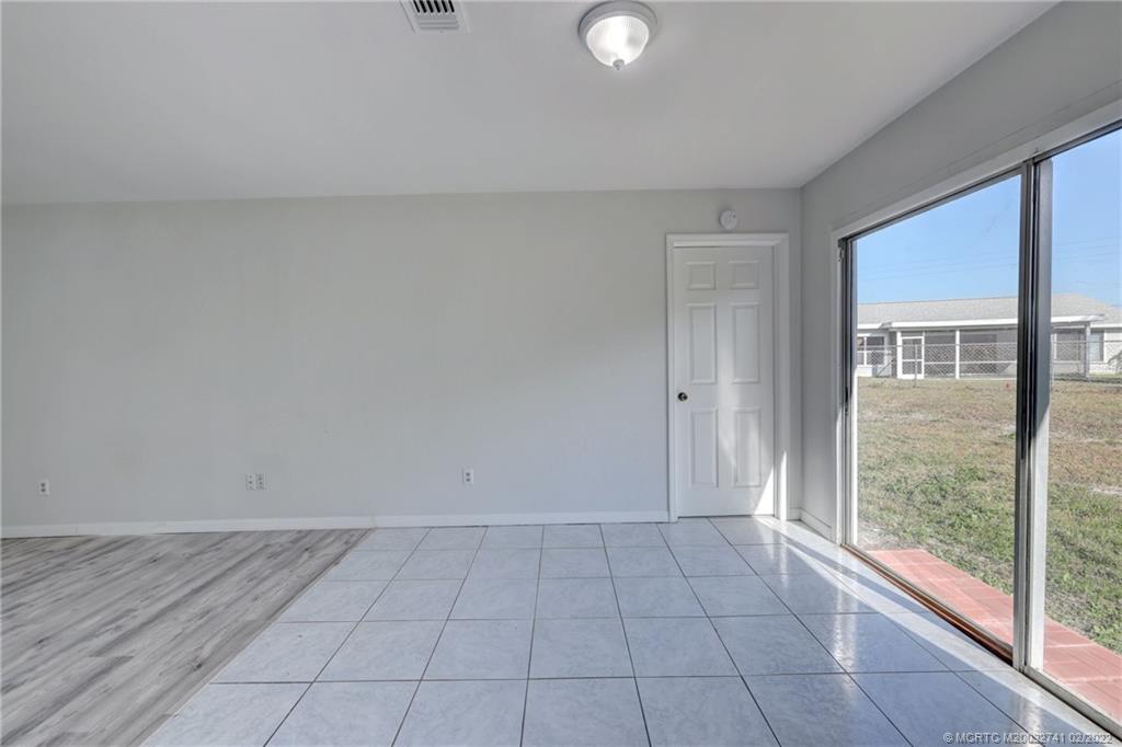 297 Southwest Homeland Road Port St. Lucie, FL 34953 - Photo 9 of 32 a view of an empty room and window