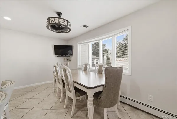 a dining room with furniture and window